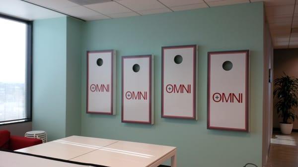 Cornhole games hung on wall. Fun job at a fun office!