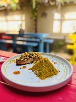 Pan-seared Salmon filet with cilantro rice with mango salsa drizzled with lemon vinaigrette