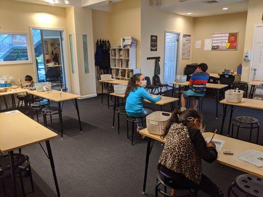 Desks are spaced 6 ft apart. Masks and PPE worn by students and staff