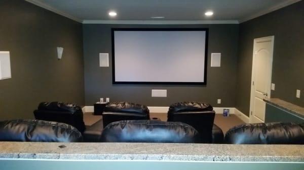 This is a Home Theater with a 120" screen, 7 comfortable theater chairs, a 7.1 in wall/ceiling Earthquake Speaker system & 4K JVC Projector.