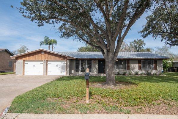 Front of Structure - Single story home featuring a garage and a front yard