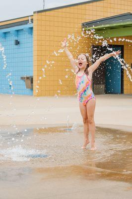 Young girl walking through water feature at Ad Astra Pool. Photo by Jeanie Webster.