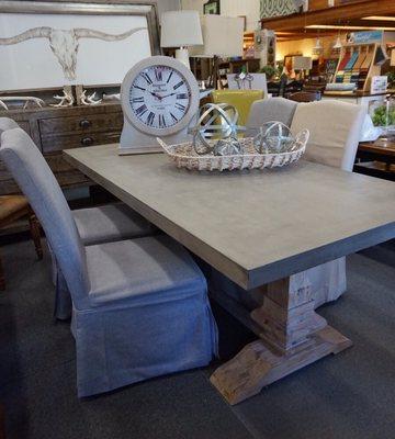 Pedestal dining table with cement top.  Dining in elegance!