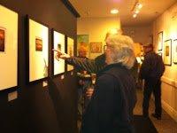 Guests appreciate art during an exhibition opening.