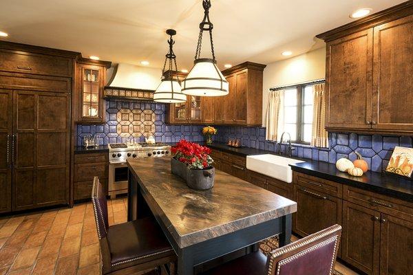 Handcrafted tiles and rich hues of blue, burgundy and terra cotta enhance this beautiful and inviting kitchen.