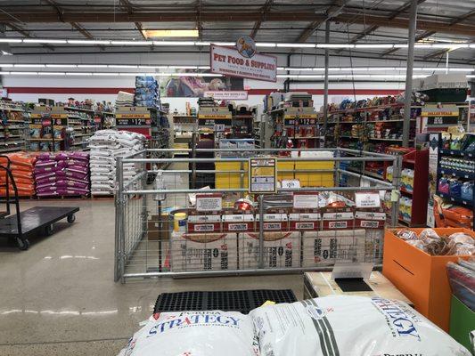 A view of pet food and supplies, along with the area where small animals are sold.