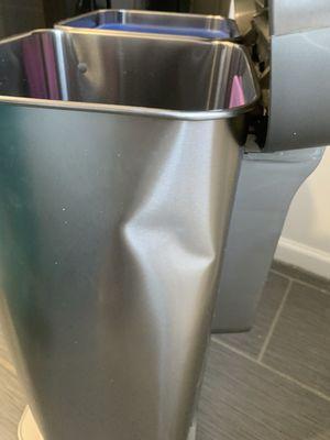 Dented trash can