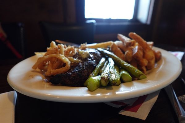 Steak with crispy onion rings, asparagus and fries 8 oz for $24