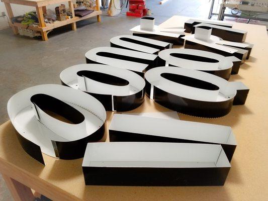 Aluminum channel letters prior to assemble.