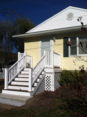 We installed new siding, windows, a new landing for the front steps and new railing.