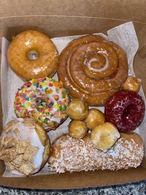 Glazed, fruity pebble, Cinnamon Toast Crunch, coconut jelly stick, glazed munchkins, red velvet and cinnoman roll.