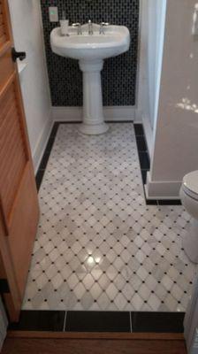 Custom marble floor in lay, with glass accent wall.