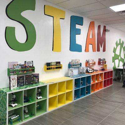 Hand-painted artwork and display cases show off what STEAM is all about!