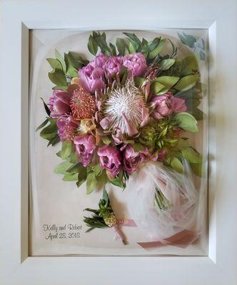 King Protea is the focal point in this preserved wedding bouquet with Tulips, Pin Cushions, and ornamental Pineapples.