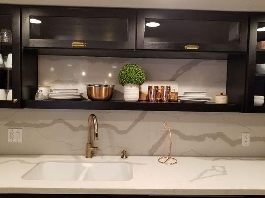 Just a second look at some of the best features of this highrise kitchen. Quartz backsplash with horizontal open glass cabinetry above.