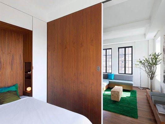 Walnut clad sliding wall on bedroom