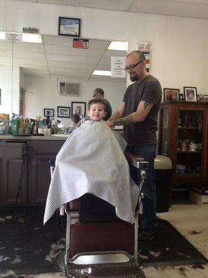 My son's first haircut by Ryan.