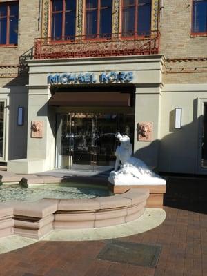 A quaint court with a beautiful fountain fronts the Michael Kors Store on the Plaza