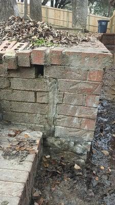 This is another example of saturated soil behind a retaining wall with no drainage which caused brick damage.