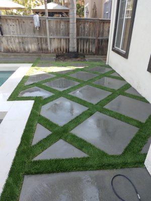 3x3 concrete squares with 6 inch strip of turf, in a 45 degree angle looks awesome .