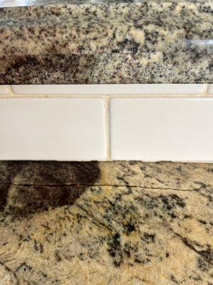 Granite countertop by kitchen sink w 10" surface split