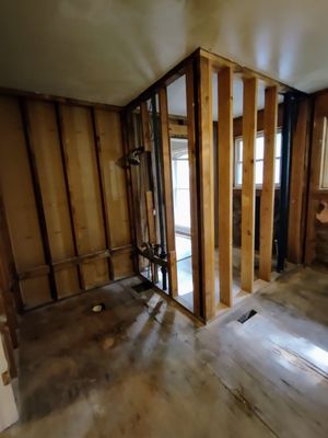 Bathroom wall and floor after demo