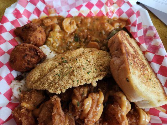 French Quarter dish = two hushpuppies,  1 catfish fillet , garlic toast , bang bang shrimp ,  white rice  under shrimp etoufee