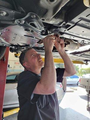 Owner Brian installing a Cat Shield on a car.