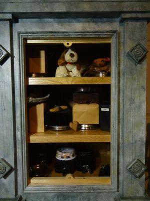 Interior of Mausoleum Cremation Urn Cabinet, with urns and personal items.