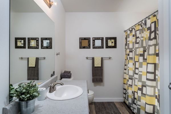 Full bathroom with shower and tub enclosure.