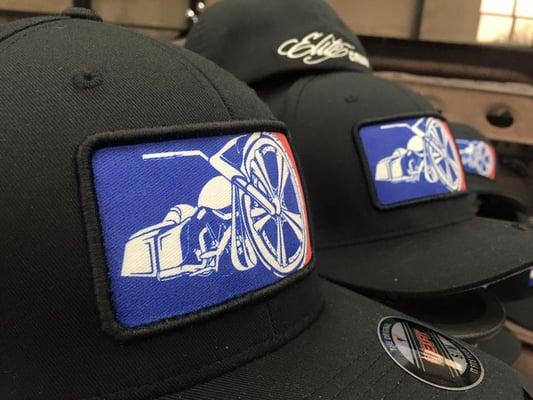 Flexfit hats for Big Wheel Baggers with screenprinted patches with puff border and direct embroidery on back placement.