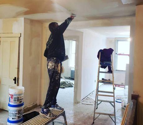 Prepping a ceiling for a fresh coat of paint.