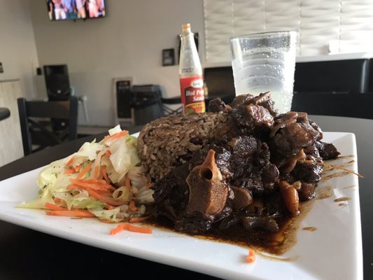 Oxtail cabbage and rice with beans and a Gingerbeer to was it down.