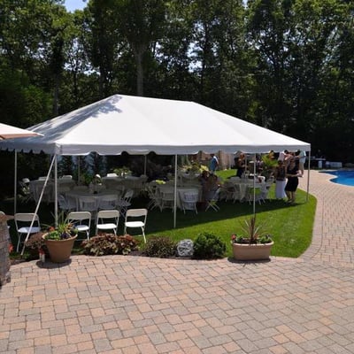 20x30 Frame tent w/ tables & chairs for a summer engagement party!