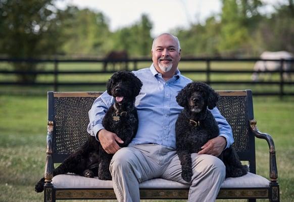 Dr. Petty with his two Portuguese Water Dogs, Kiki and Joy