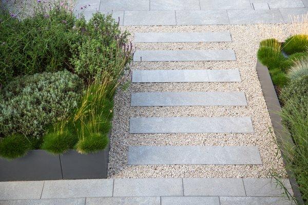 Steppers, pea gravel, pavers and fescue grasses