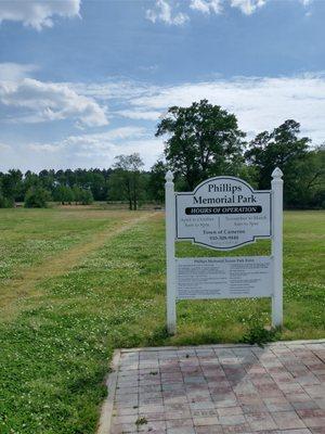 Park hours and dirt path to pond seating