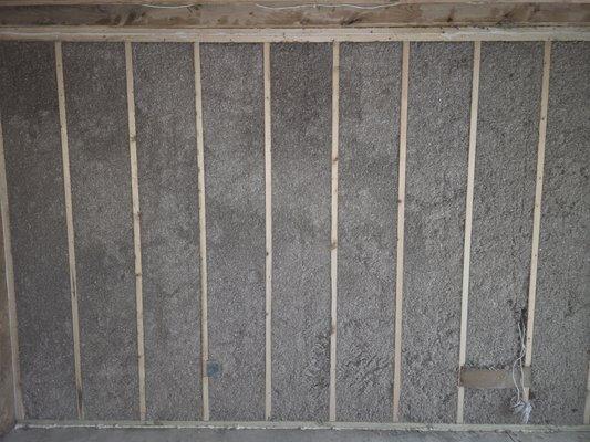 Sprayed cellulose in new construction or open walls