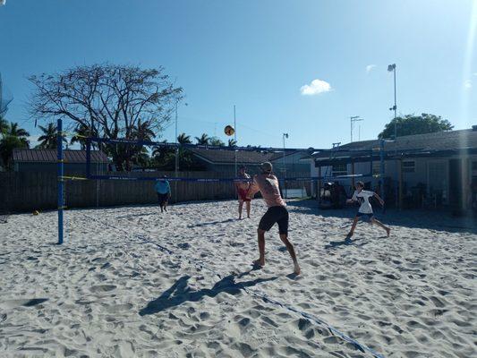 Player bumping the Volleyball above the net.