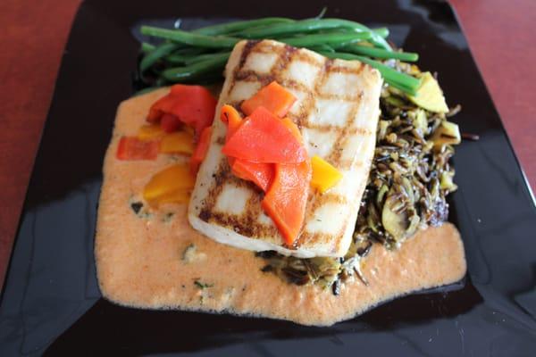 Mahi Mahi over wild rice with tomato cream.