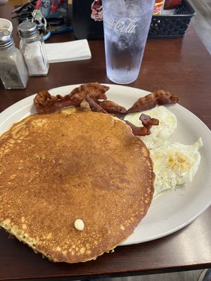 Two giant pancakes with eggs bacon. The "Get UR done"lol