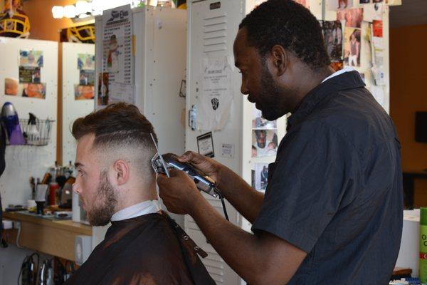 Sawdy Cutting Customer's Hair