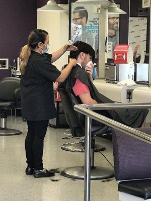 Wear mask while getting hair cut.