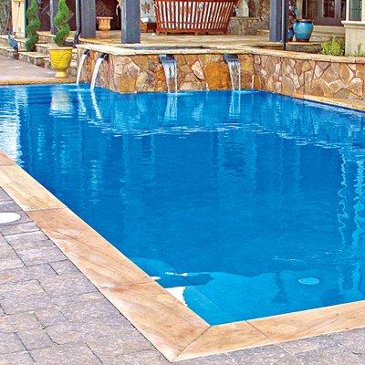 Rectangular concrete pool and raised spa with four channel-style, cascade spillways