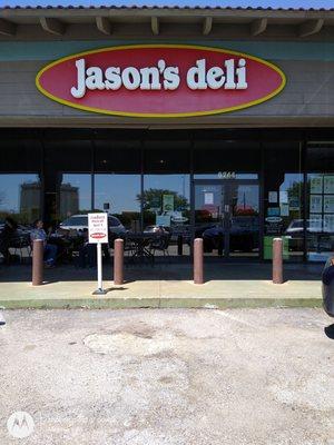 Entrance. Tables outside and curbside parking.