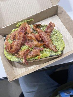 Avocado toast topped with bacon