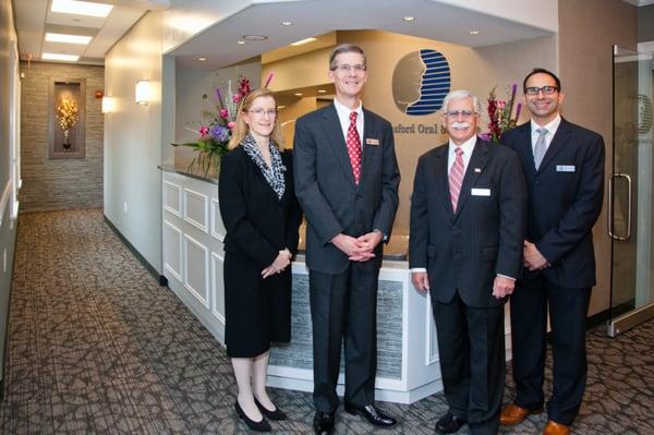 Drs. Amy Field, Thomas Trowbridge, Jeffrey Stone and Sotirios Diamantis (L to R) in front of our Chelmsford reception desk.