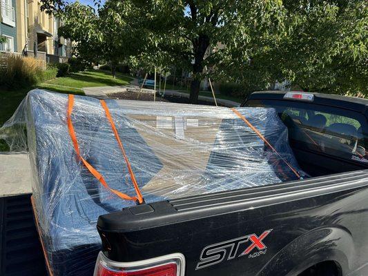 Wrapped and protected couch loaded and strapped.