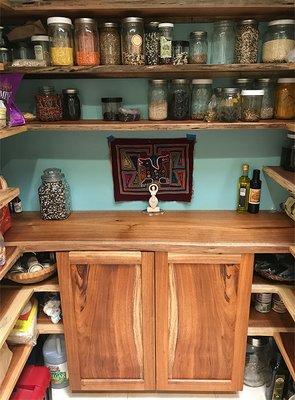 Black acacia pantry with book matched doors and live-edge counter. Oil/wax finish.