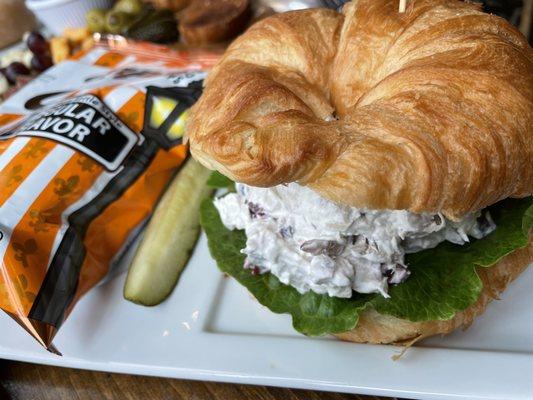 Chicken salad on croissant with kettle chips and pickle